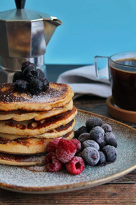 Sustainable-business-culture-eats-strategy-breakfast-photo of pancake stack with sugar frosted berries and stove top coffee maker in background