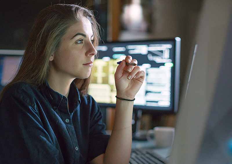  ESG and Sustainability Reporting – are you engaging your investors? - image of  woman investor looking at a screen with other data screens in the background