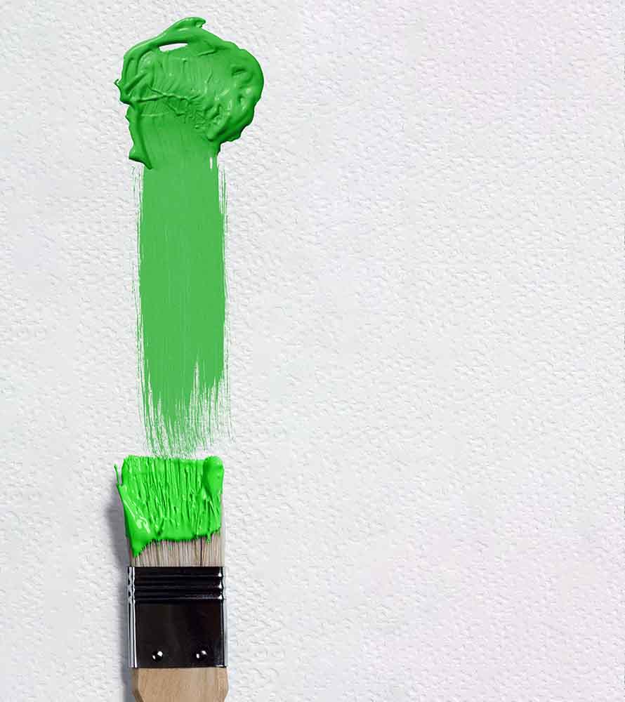 Greenwashing - more focus in 2023. Image of paintbrush with streak of green paint against textured paper